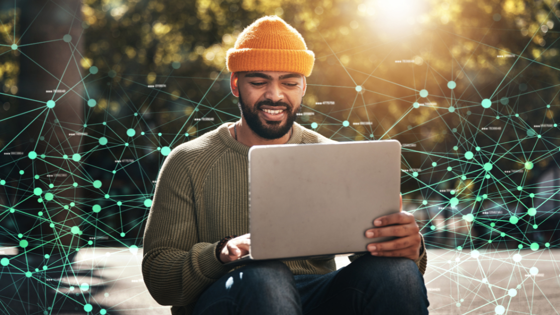 Researcher sitting outside on a bright day, working on a laptop, with datapoints overlayed on top of the image. Chercheur travaillant sur son ordinateur portatif lors d’une journée radieuse; des points de données sont superposés sur l’image.