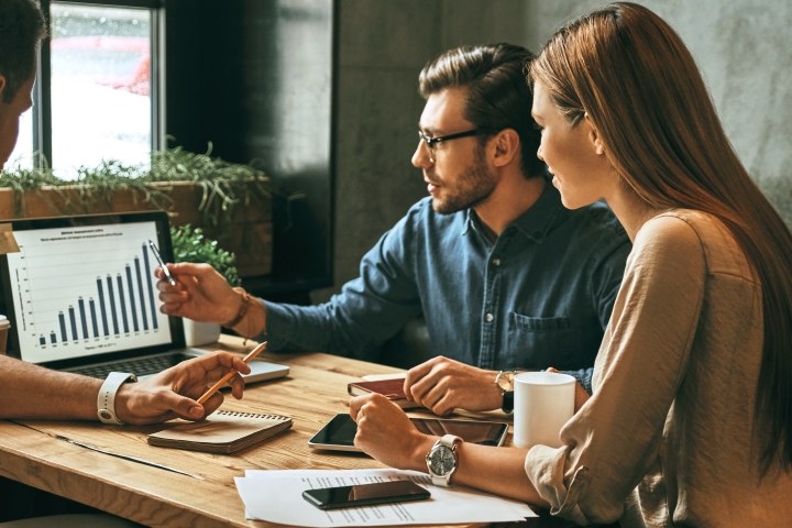 people talking in front of computer